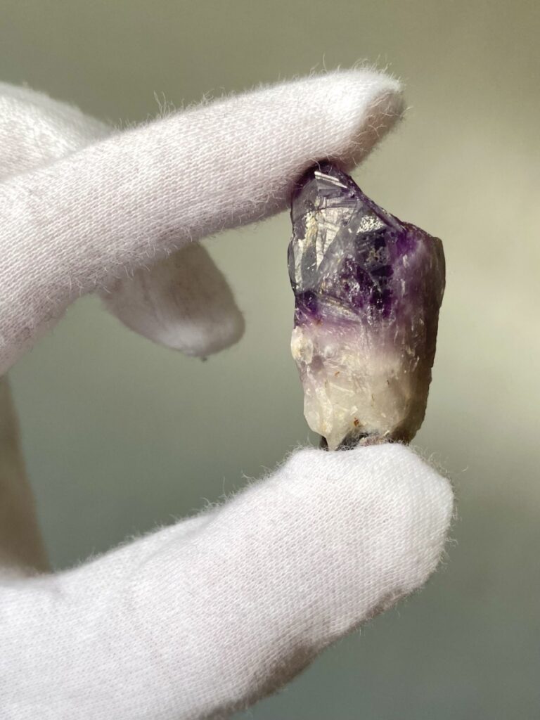 Color zoning in rough amethyst crystal. (Photo by Olena Rybnikova).